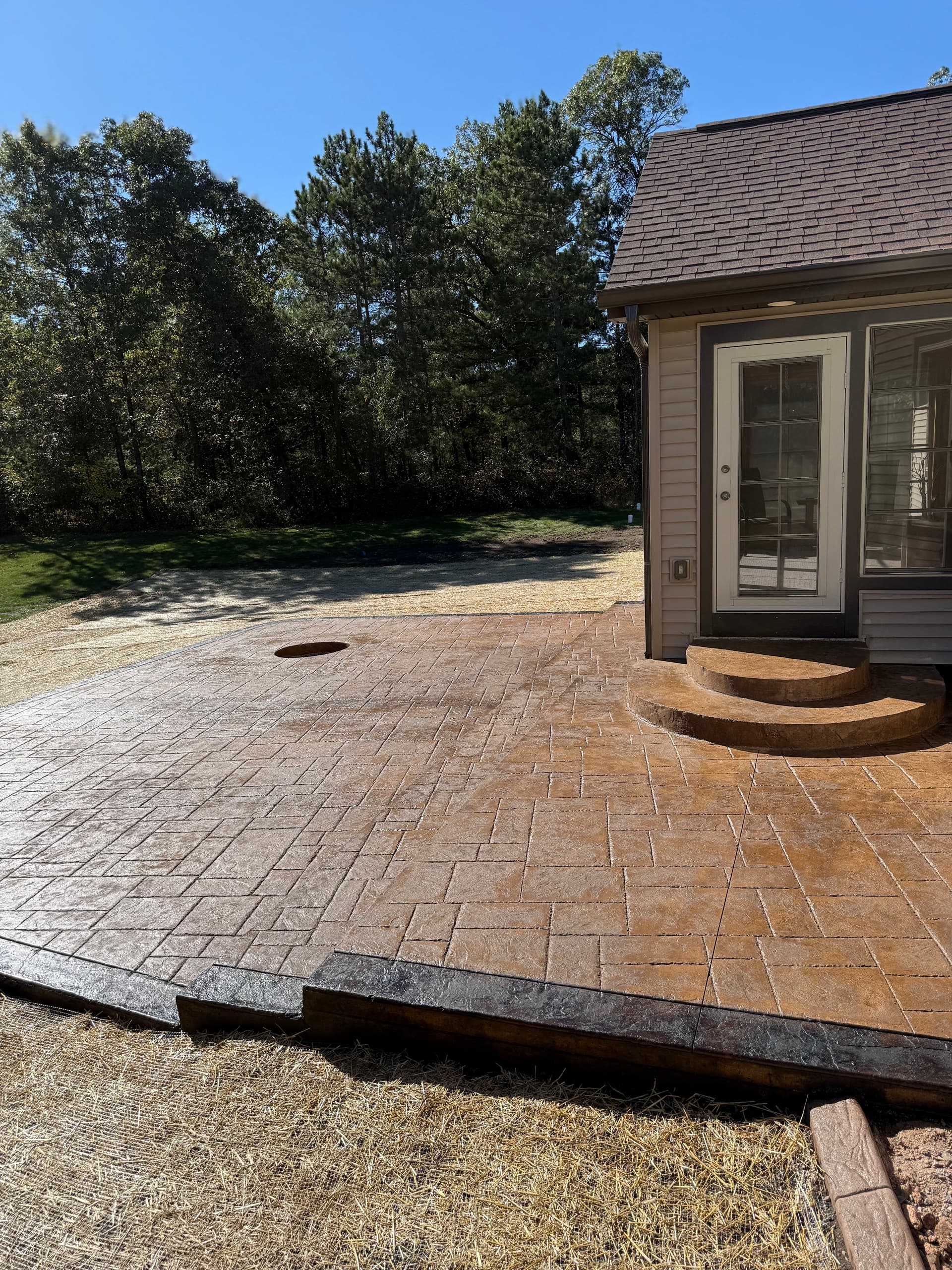 Gallery photos for Custom Stamped Concrete Patio with In-Ground Fire Pit and Two-Tone Border: Image #2